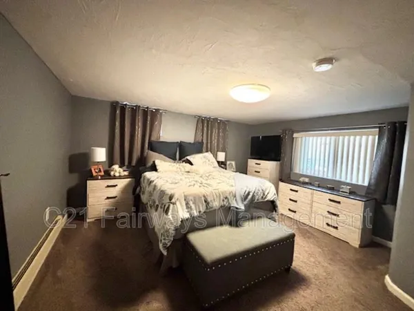 a bed room with a bed and furniture