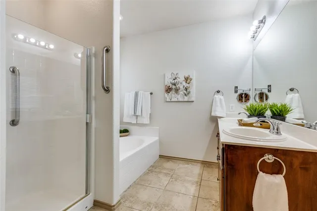 a bathroom with a sink a mirror and a shower