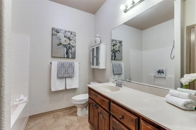 a spacious bathroom with a sink toilet and shower