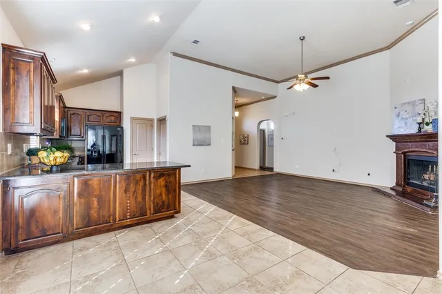 a view of kitchen with sink and refrigerator