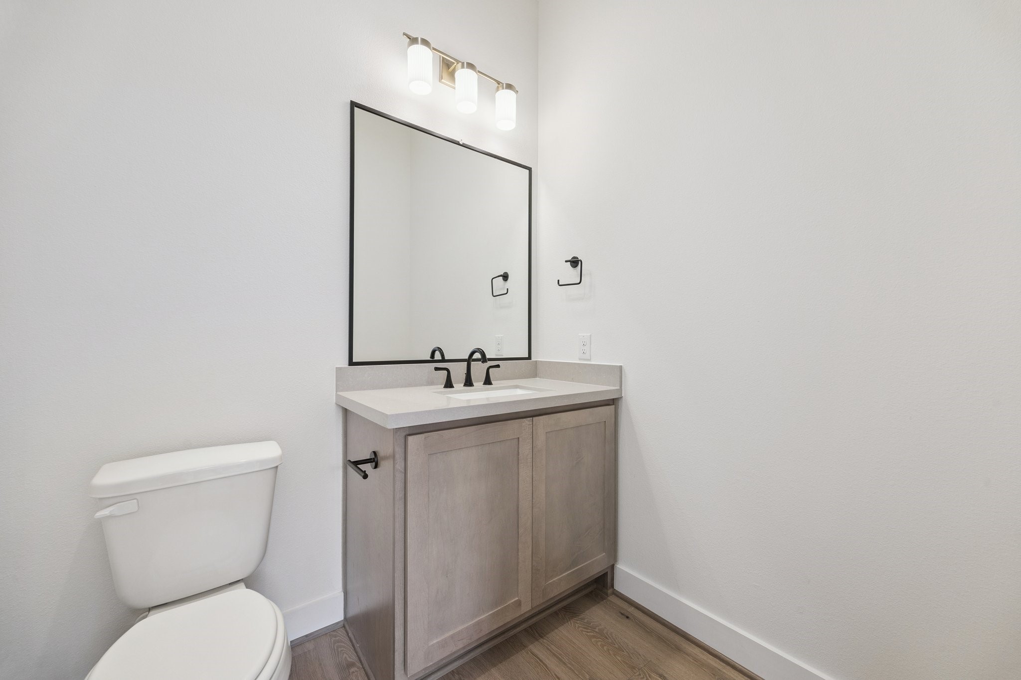 2211 Saxon Drive Houston, TX 77018 - Photo 31 of 32 a bathroom with a toilet a sink and mirror