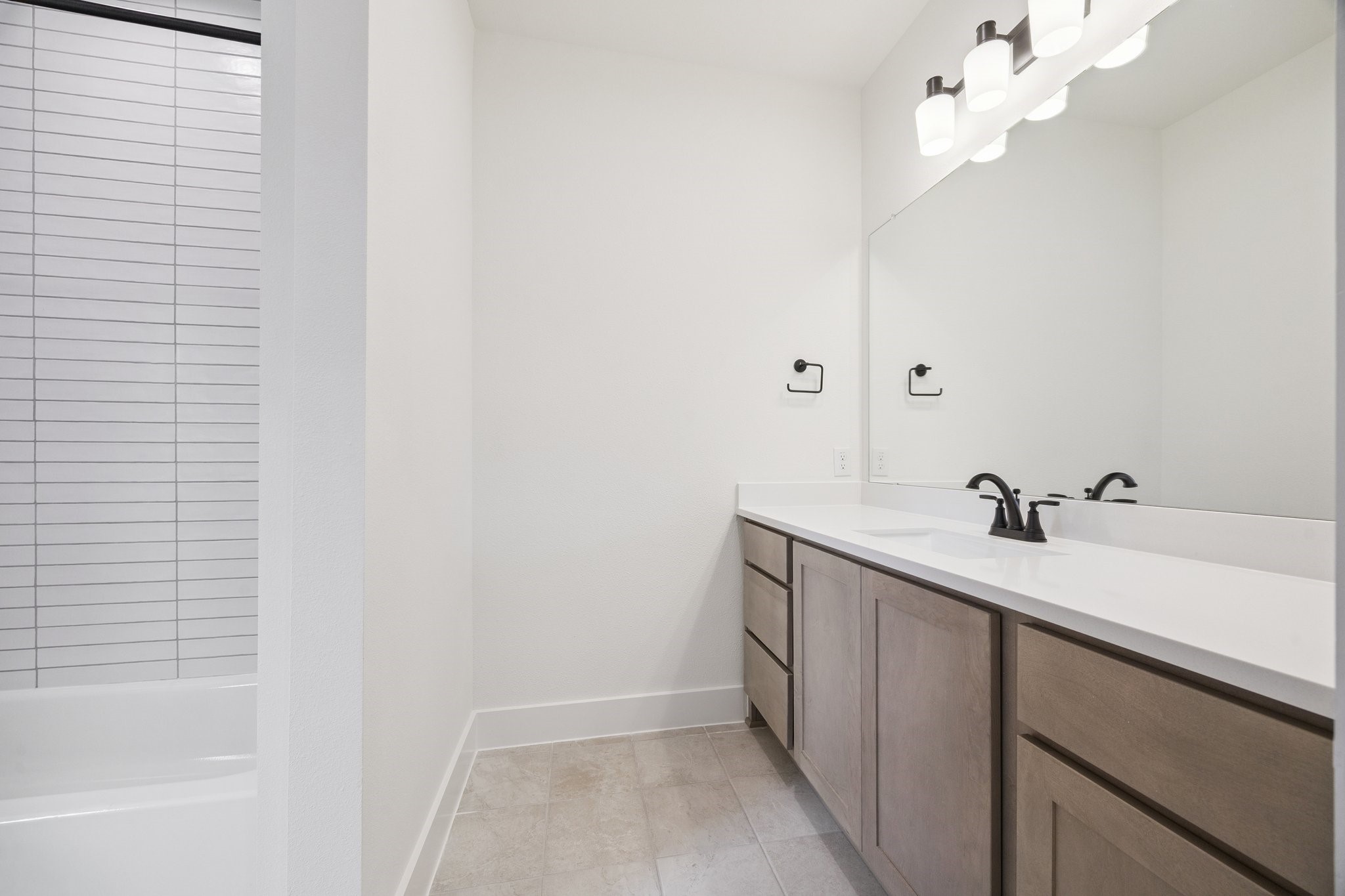 2211 Saxon Drive Houston, TX 77018 - Photo 32 of 32 a bathroom with a sink a mirror and a bathtub