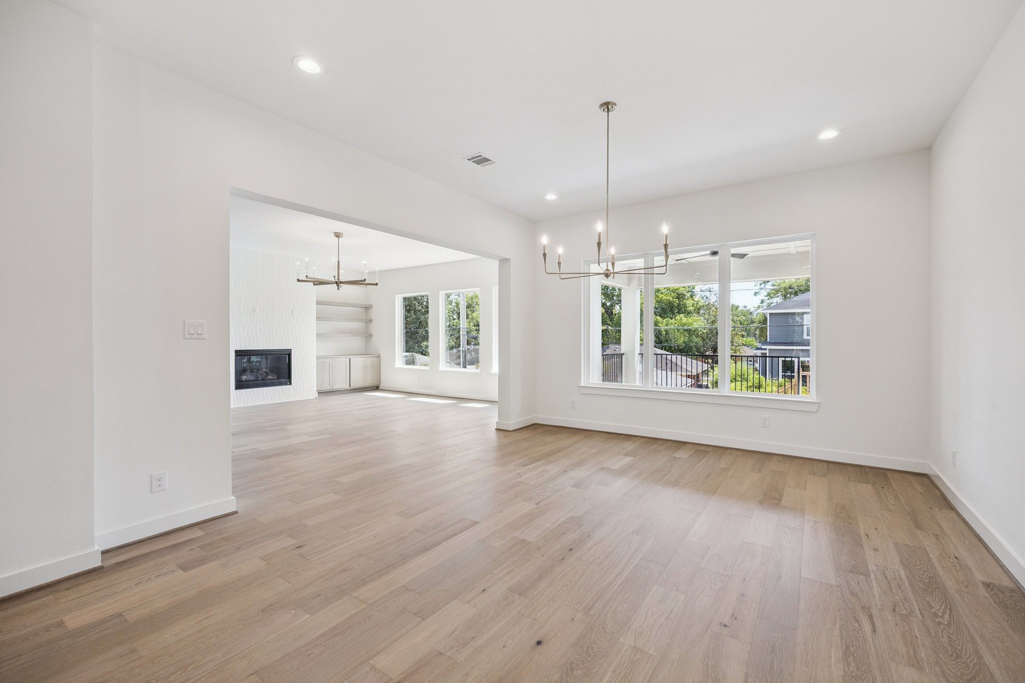 2211 Saxon Drive Houston, TX 77018 - Photo 5 of 32 a view of an empty room with wooden floor and a window