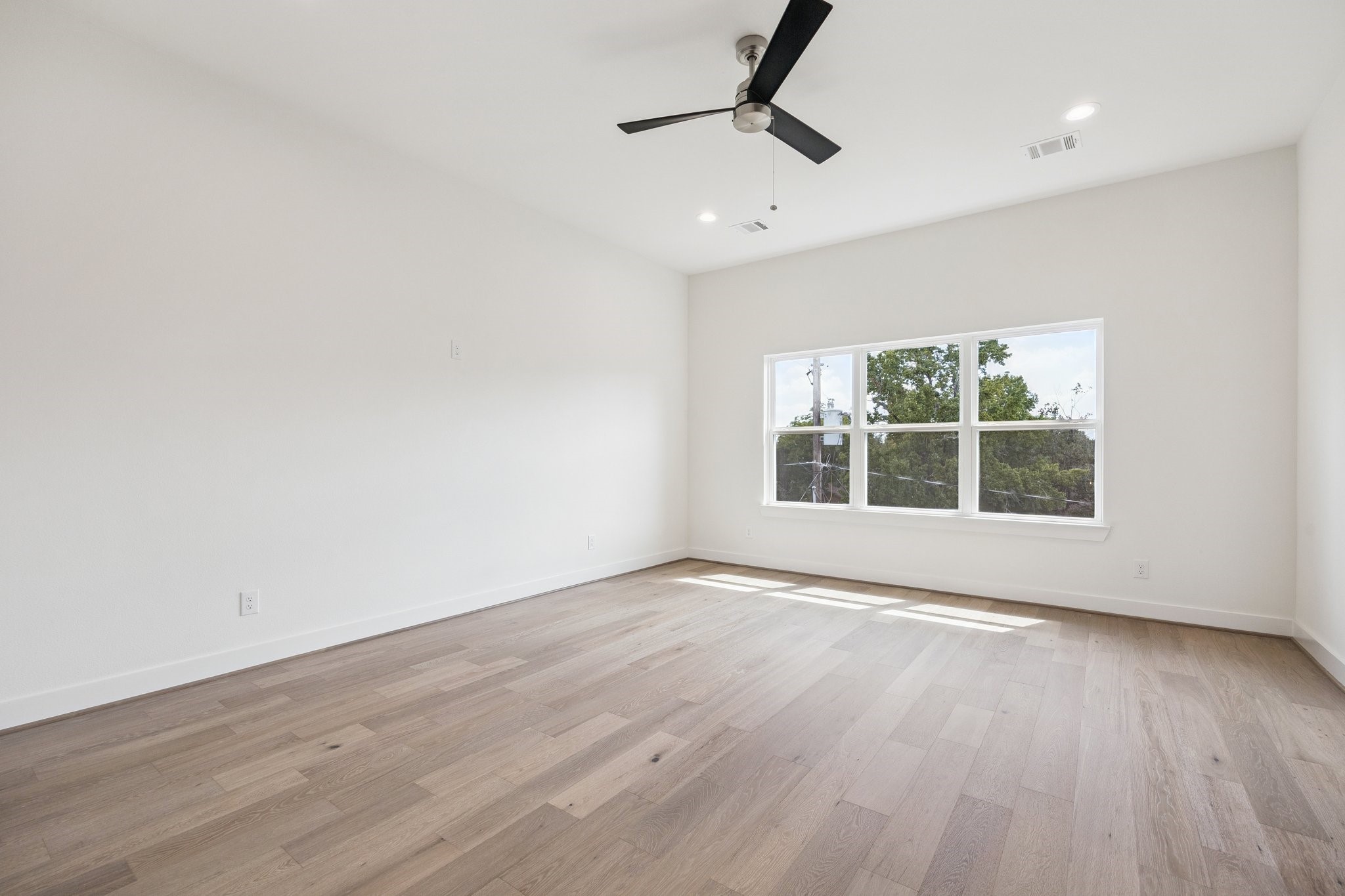 2211 Saxon Drive Houston, TX 77018 - Photo 7 of 32 a view of an empty room with wooden floor and a window