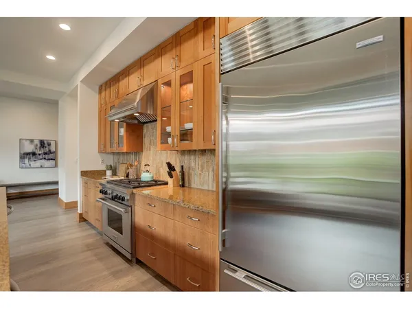 a kitchen with a sink and wooden floor