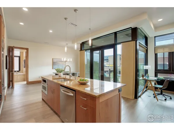 a living room with furniture a flat screen tv and a large window