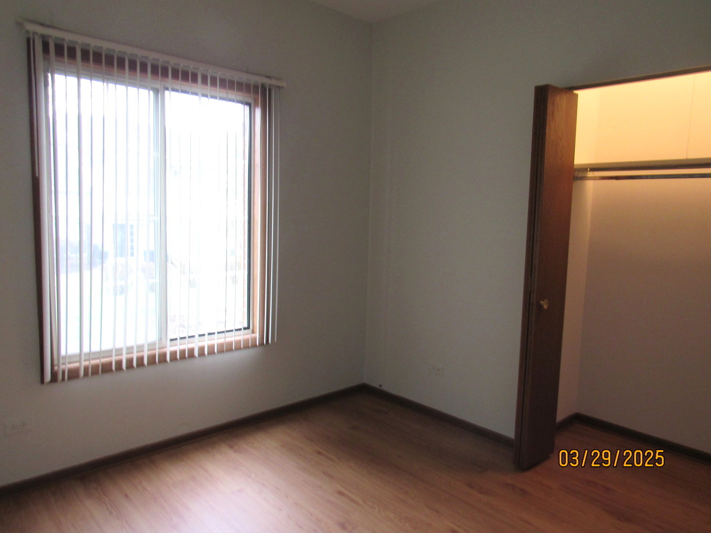 1735 Chesapeake Lane, Unit 7 Schaumburg, IL 60193 - Photo 20 of 22 a view of an empty room with wooden floor and a window