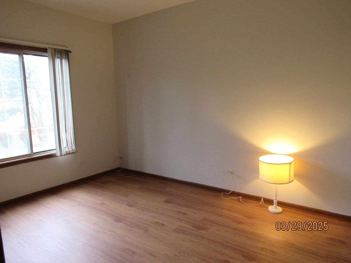 1735 Chesapeake Lane, Unit 7 Schaumburg, IL 60193 - Photo 21 of 22 an empty room with wooden floor and windows