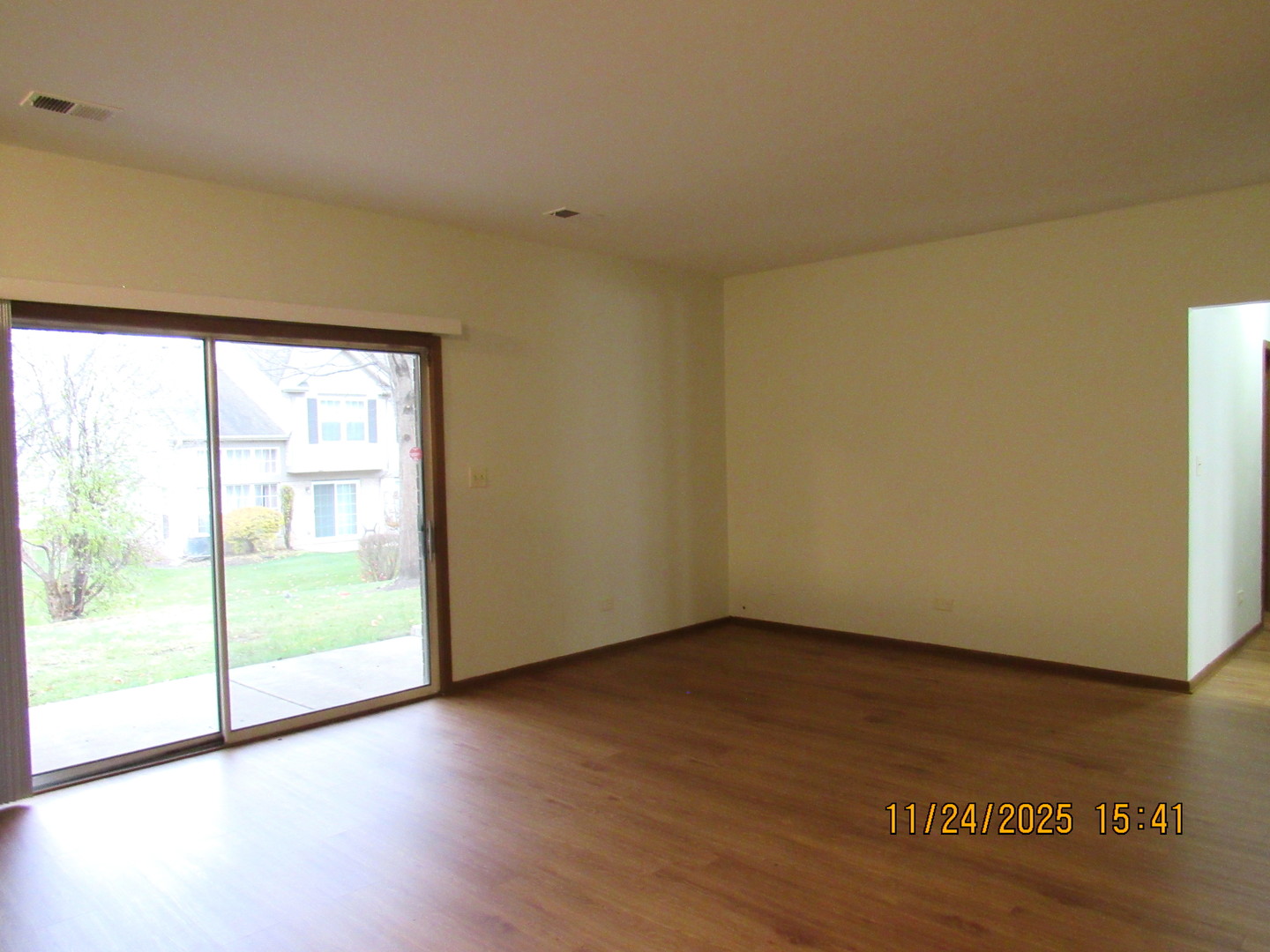 1735 Chesapeake Lane, Unit 7 Schaumburg, IL 60193 - Photo 4 of 22 a view of an empty room with wooden floor and a window