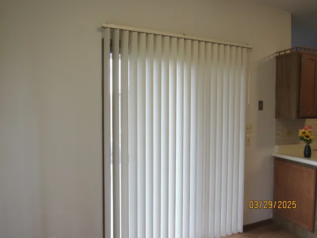 a view of a room with a wooden door