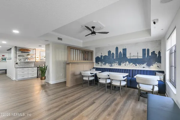 a living room with lots of furniture and kitchen view
