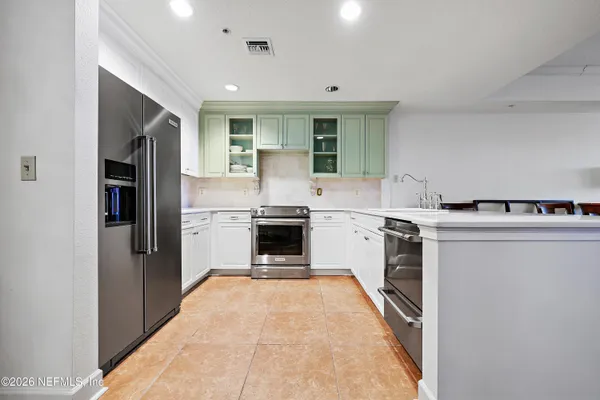 a kitchen with a refrigerator sink and stove