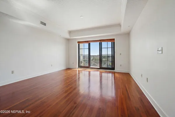 wooden floor in an empty room with a window