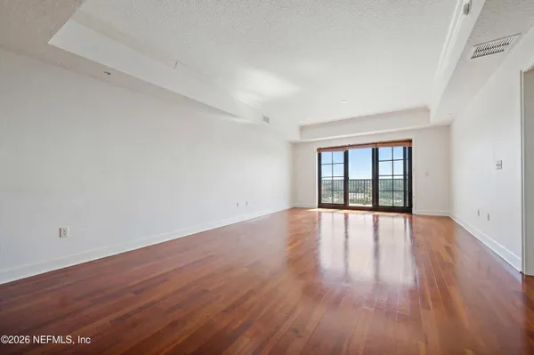 wooden floor in an empty room with a window