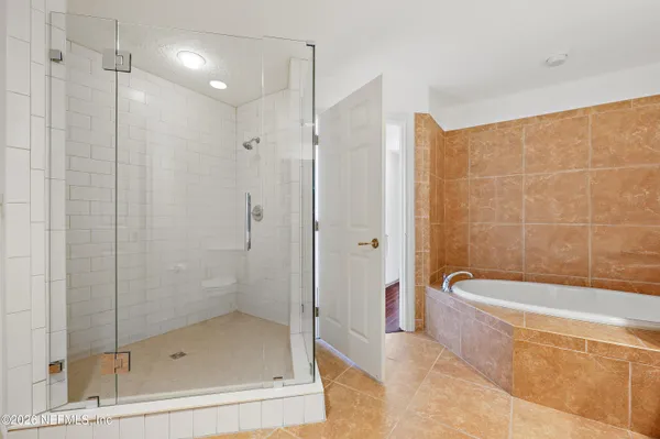 a bathroom with a shower and a bathtub