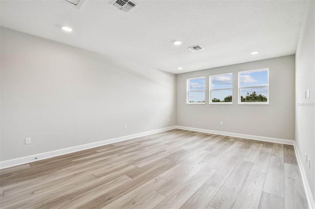 17019 Overstory Road Orlando, FL 32820 - Photo 26 of 85 wooden floor in an empty room with a window
