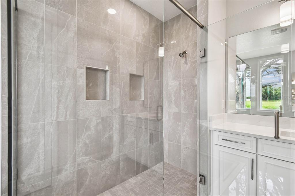 17019 Overstory Road Orlando, FL 32820 - Photo 29 of 85 a bathroom with a shower and a sink