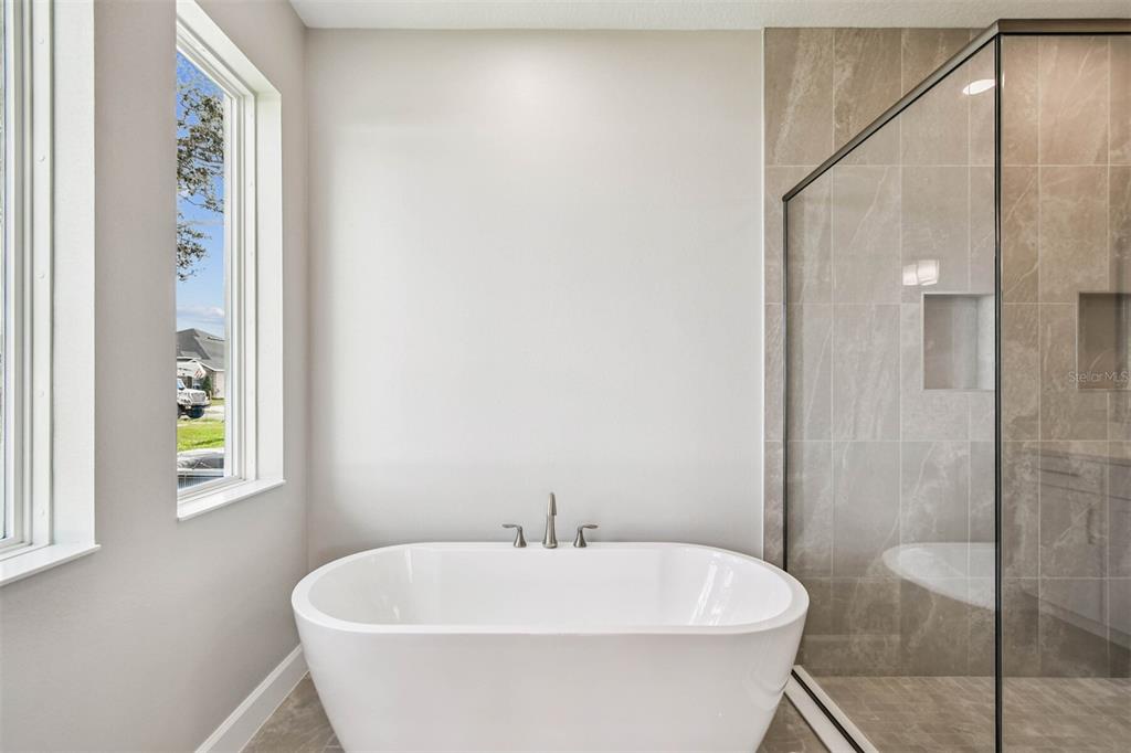 17019 Overstory Road Orlando, FL 32820 - Photo 31 of 85 a white bath tub sitting next to a white sink