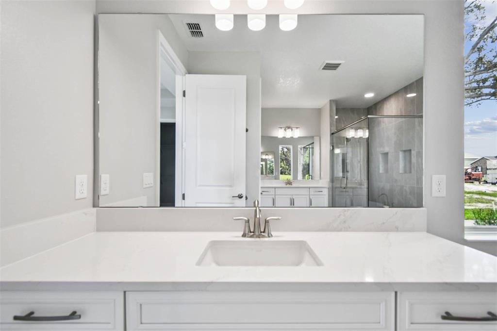 17019 Overstory Road Orlando, FL 32820 - Photo 32 of 85 a bathroom with a bathtub and a sink