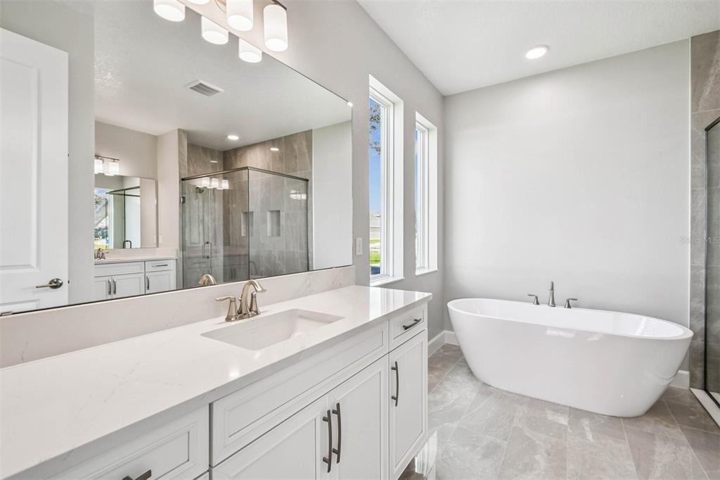 17019 Overstory Road Orlando, FL 32820 - Photo 33 of 85 a bathroom with a double vanity sink mirror and double