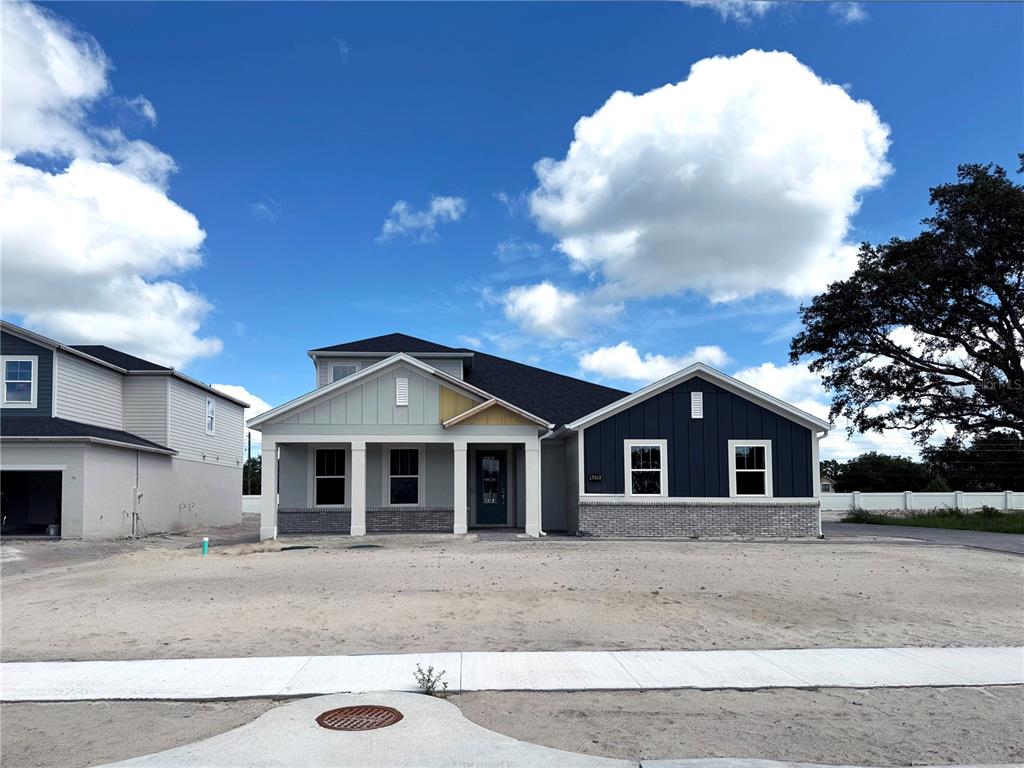 17019 Overstory Road Orlando, FL 32820 - Photo 80 of 85 a front view of a house with a garden