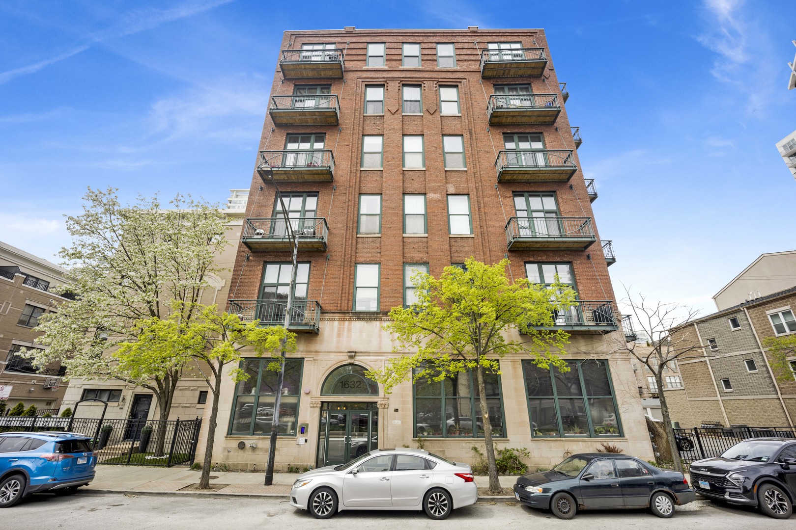 1632 South Indiana Avenue, Unit 409 Chicago, IL 60616 - Photo 1 of 21 a front view of a building and car parked