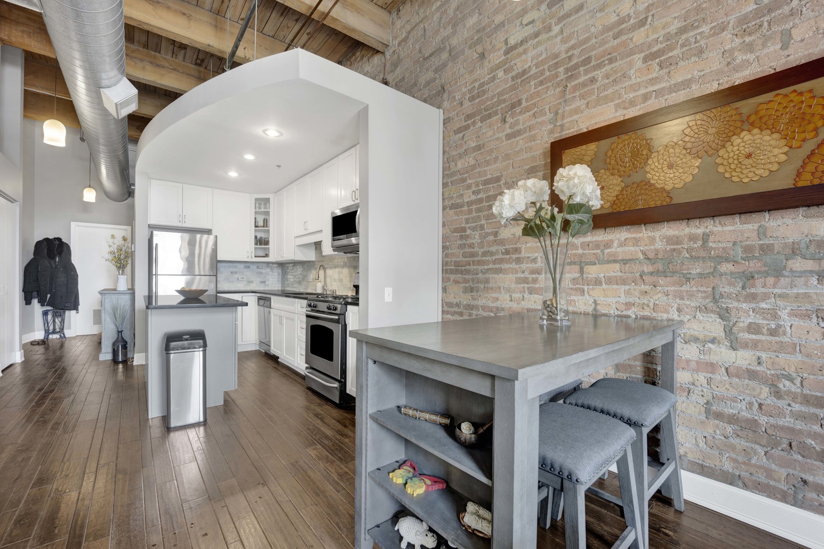 1632 South Indiana Avenue, Unit 409 Chicago, IL 60616 - Photo 4 of 21 a kitchen with cabinets and wooden floor