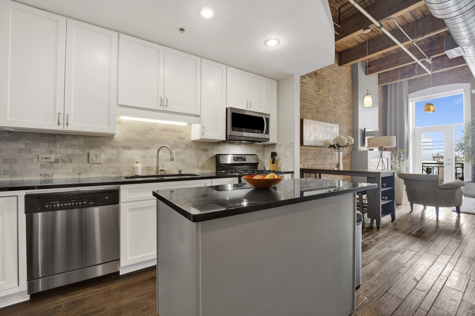 1632 South Indiana Avenue, Unit 409 Chicago, IL 60616 - Photo 7 of 21 a kitchen with granite countertop a sink cabinets and wooden floor