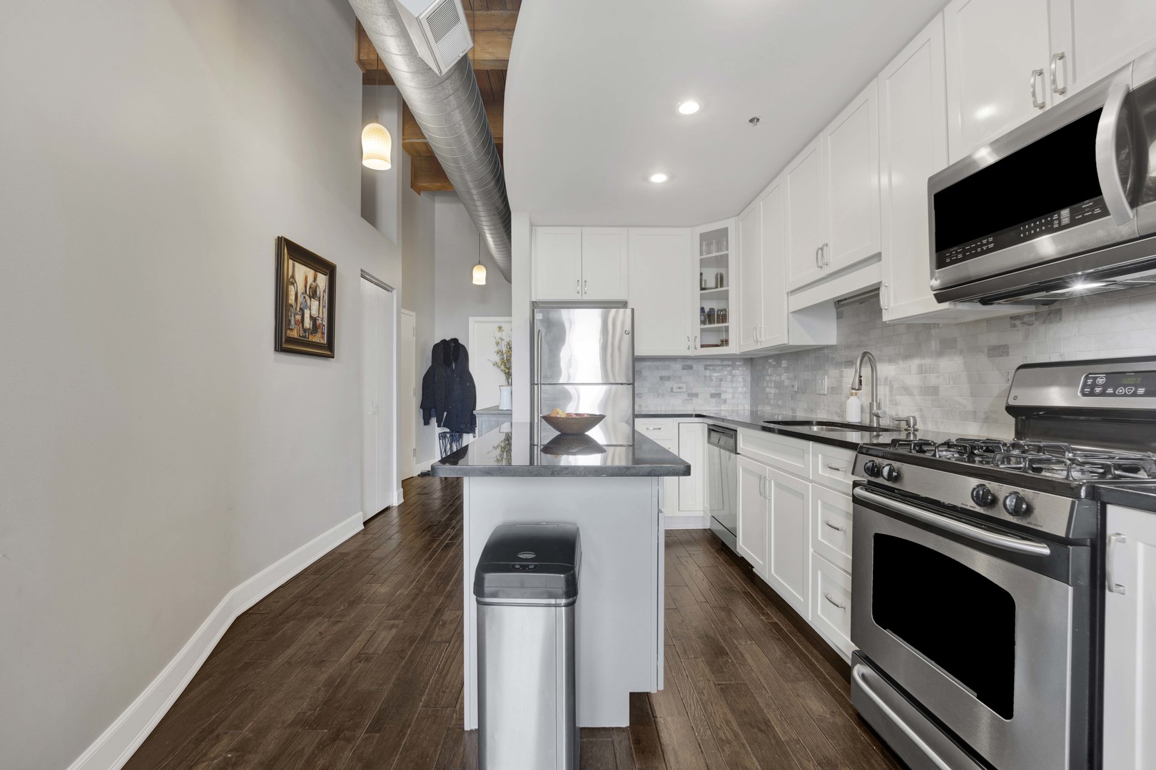 1632 South Indiana Avenue, Unit 409 Chicago, IL 60616 - Photo 8 of 21 a kitchen with stainless steel appliances a stove microwave and sink