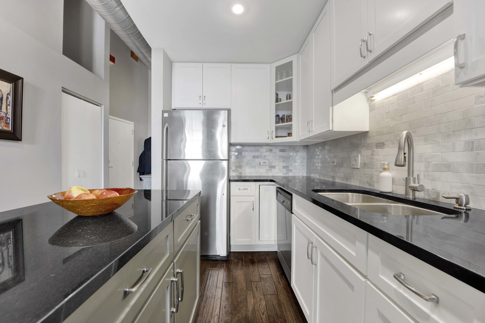 1632 South Indiana Avenue, Unit 409 Chicago, IL 60616 - Photo 9 of 21 a kitchen with stainless steel appliances granite countertop a sink a refrigerator and a stove