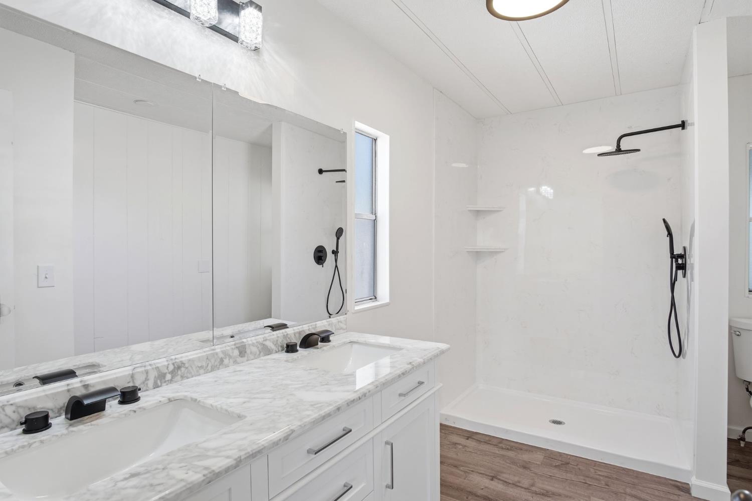 1200 South Carpenter Road, Unit 10 Modesto, CA 95351 - Photo 16 of 27 a bathroom with a granite countertop sink and a mirror