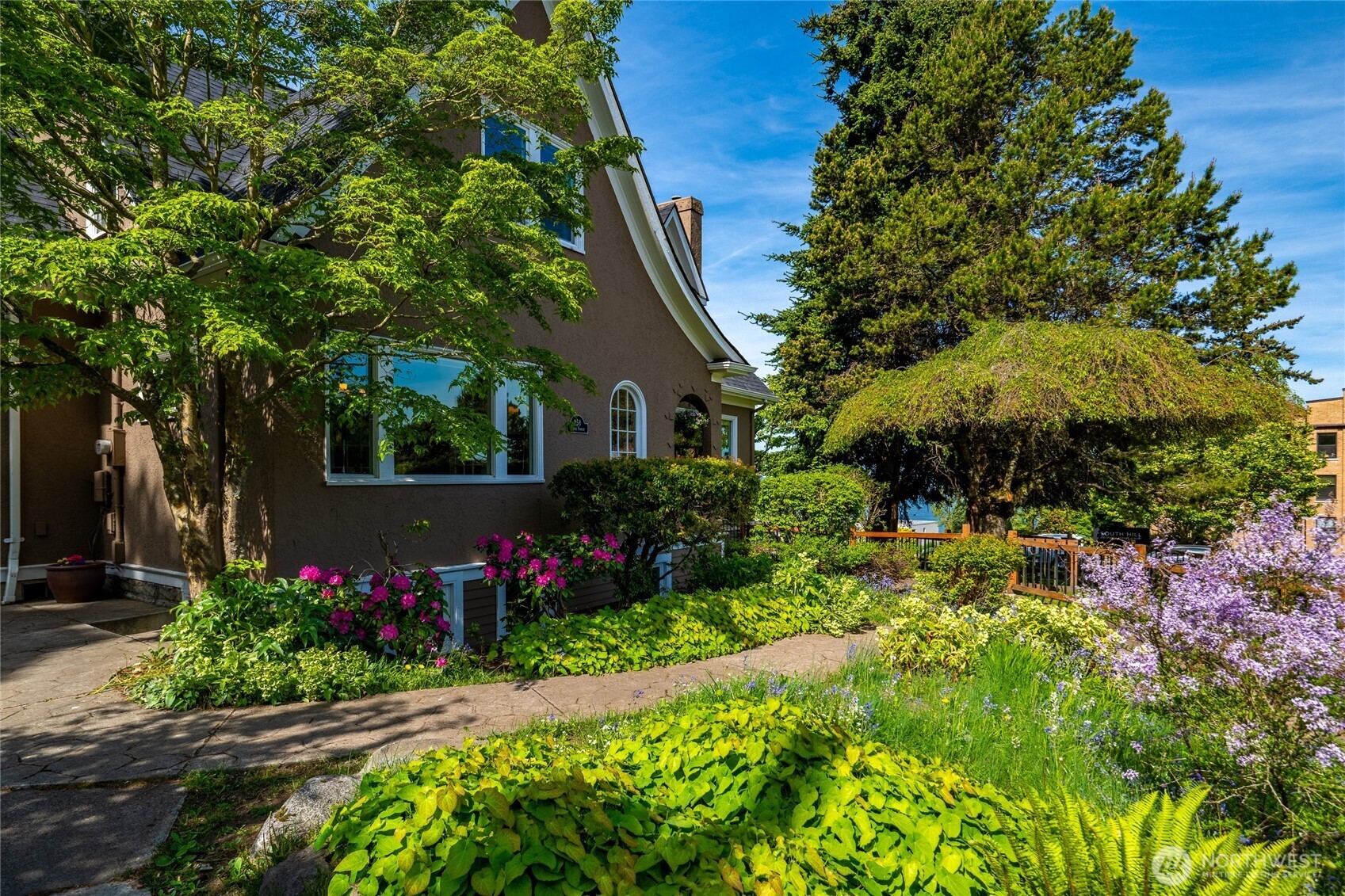 258 North Forest Street Bellingham, WA 98225 - Photo 3 of 40 a view of a garden with flower plants and large trees