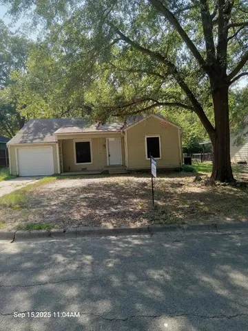 a backyard of a house with yard and garage