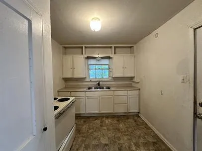 a kitchen with a sink and cabinets