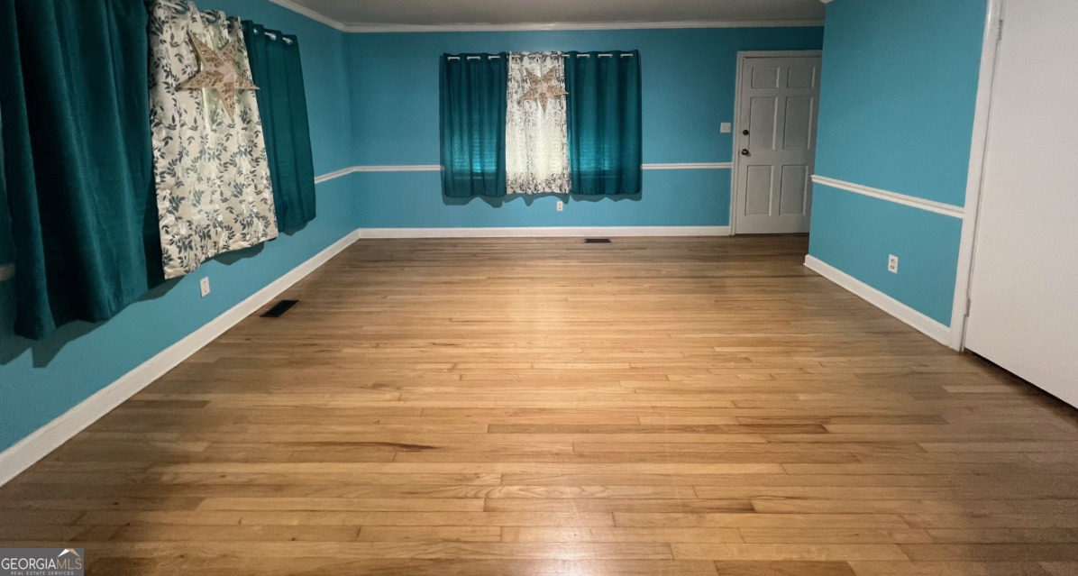 601 Linton Road South Sandersville, GA 31082 - Photo 12 of 24 a view of an empty room with window and stairs