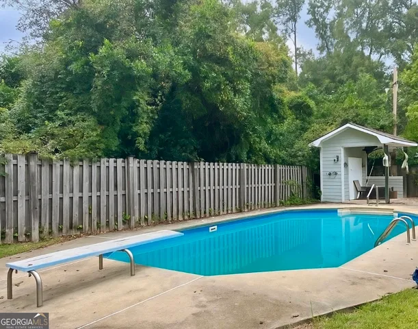 a view of a bathtub and iron fence