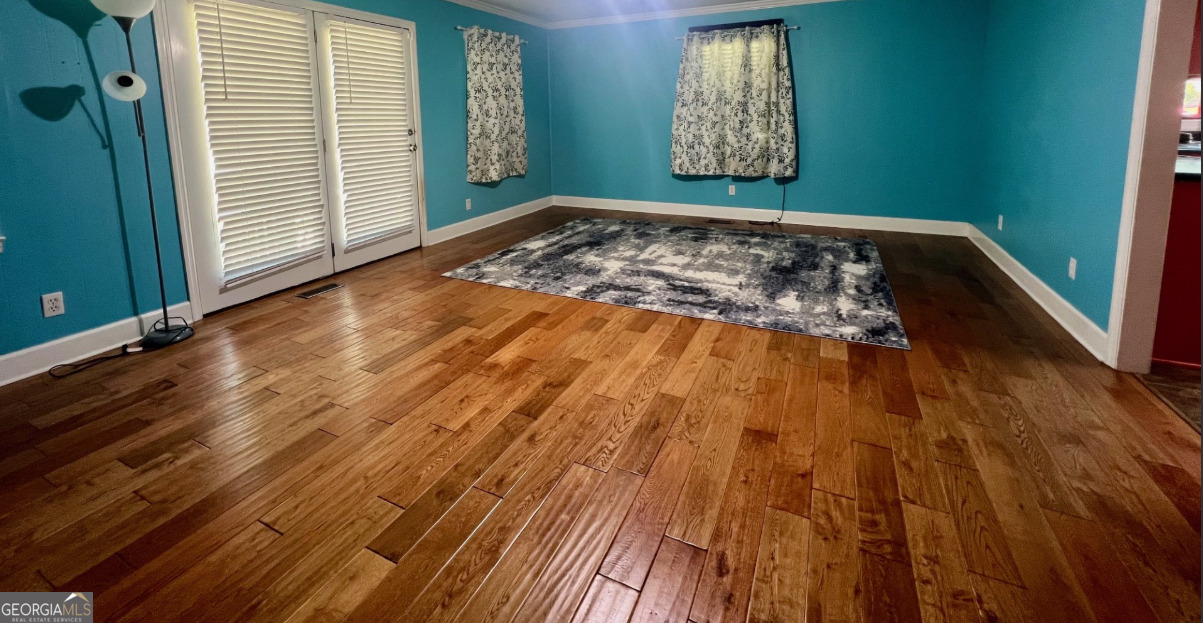 601 Linton Road South Sandersville, GA 31082 - Photo 7 of 24 a view of a room with wooden floor and window