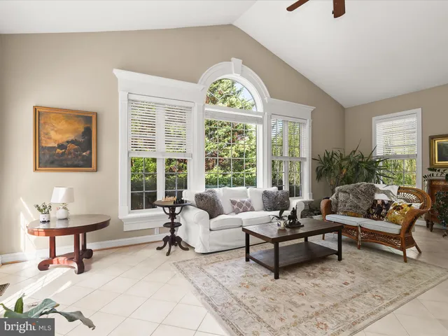 a kitchen with stainless steel appliances granite countertop a stove top oven a sink dishwasher a dining table and chairs with wooden floor