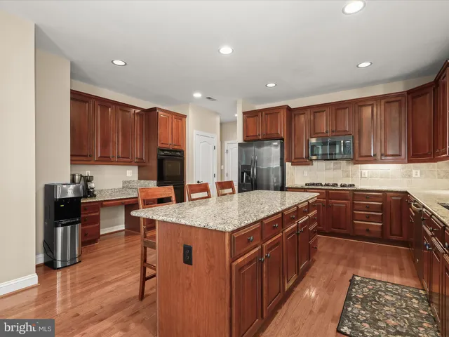 a dining room with furniture a chandelier and wooden floor