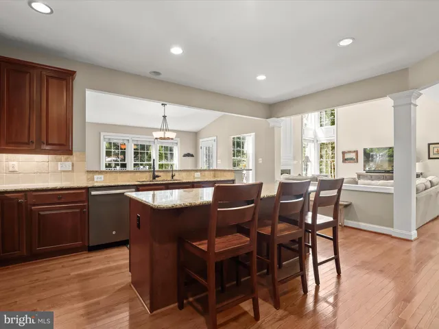 a living room with furniture kitchen and a table