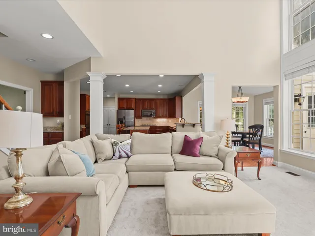 a spacious bedroom with a large bed and a chandelier