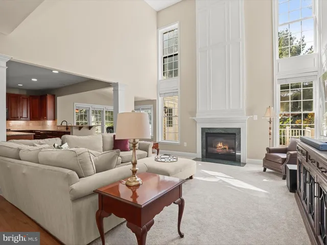 a spacious bedroom with a large bed chandelier and a window