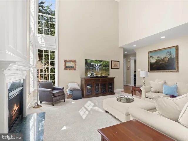a large bed sitting in a bedroom next to a window