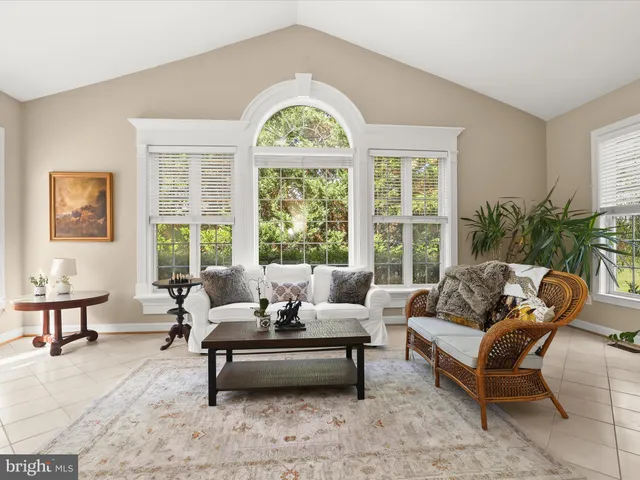 a bathroom with a granite countertop tub sink shower and mirror