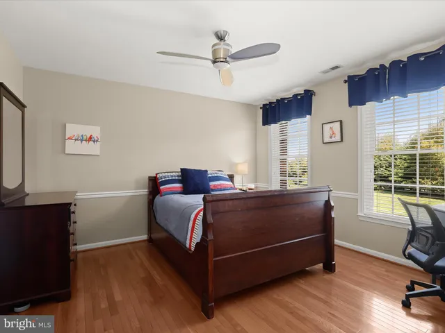 a view of a yard in front of a house with large tree