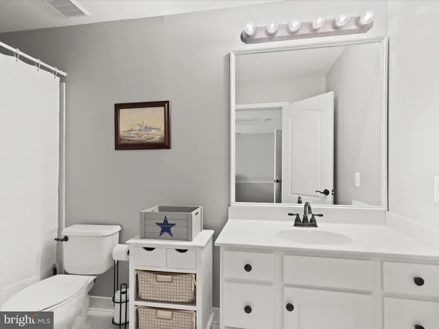 a view of a house with a big yard and large trees