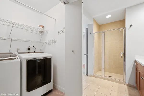 a view of a bathroom with washing machine and sink