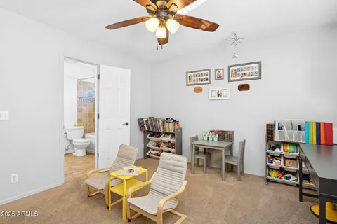 a living room with furniture and a bookshelf