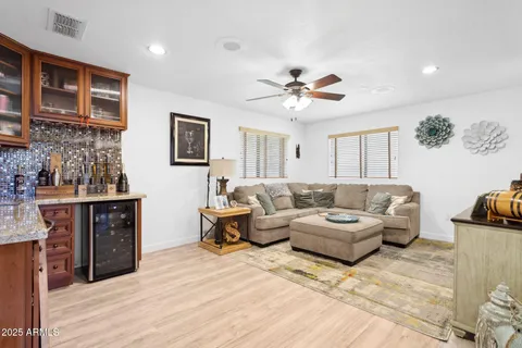 a living room with furniture a ceiling fan and a rug