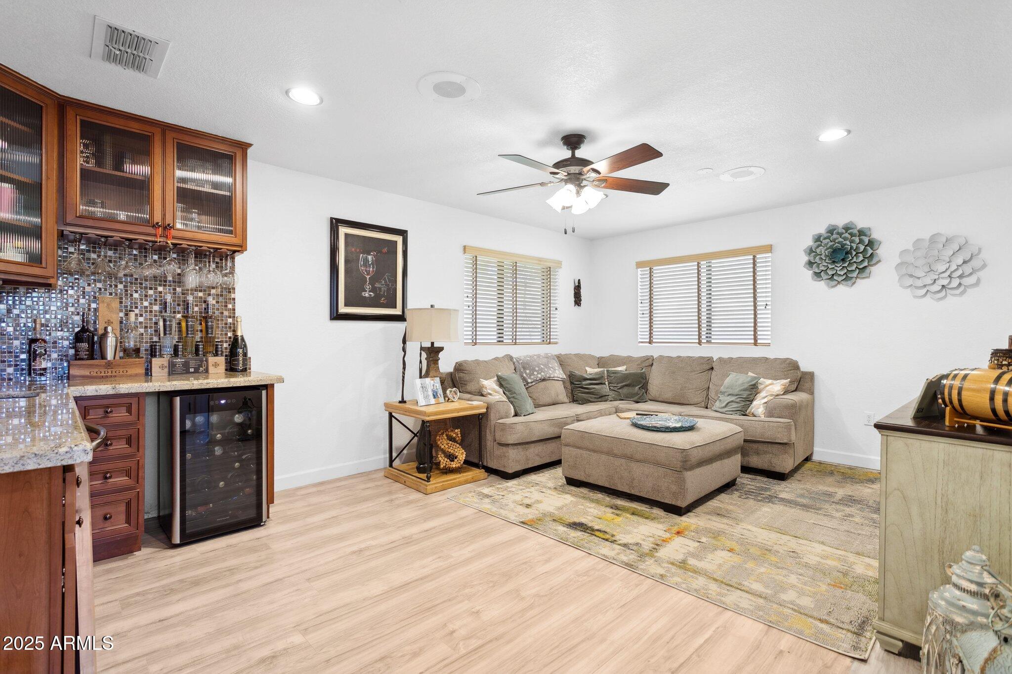 1255 West Sea Shell Drive Gilbert, AZ 85233 - Photo 15 of 34 a living room with furniture a ceiling fan and a rug